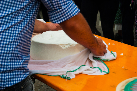 Cheesemaker showing the proceeding to make cheese from the milkの写真素材