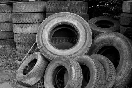 Worn wheels stacked in a tire shopの写真素材
