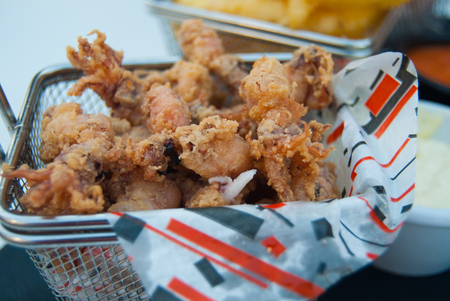 Close-up of fried little squids with white sauce on the tableの写真素材