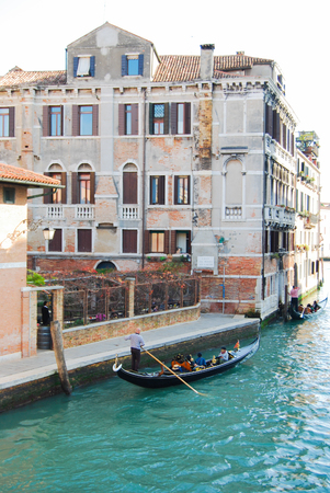 Gondolas  in a Venetian canal and characteristic old housesの写真素材
