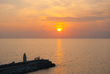 Little port with lighthouse during the colorful sunsetの写真素材