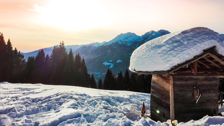 Landscape on snowy Dolomites with little wooden play house for childrenの写真素材