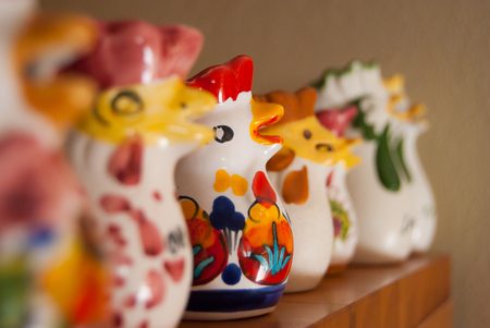 Italian handmade hens colored by hand in line on a shelfの写真素材