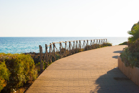 Curved pedestrian catwalk with typical wooden parapet of the spanish island of Menorcaの写真素材