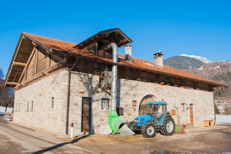 Tractor turned off close to a flours producing site with mountains on the backgroundの写真素材