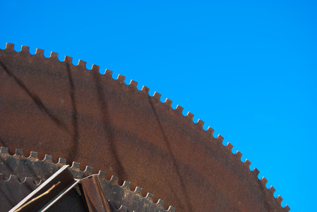 Denticles of a brown and old circular saws for marble outside in Carraraの写真素材