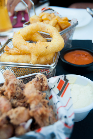 Close-up of fried food with white and red sauce on the tableの写真素材