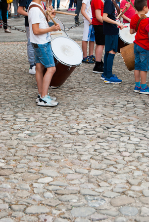 Children with chopsticks in their hands making general rehearsals for a folk event in Assisiのeditorial素材