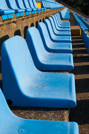 Light blue and plastic seats arranged in an amphitheaterの写真素材