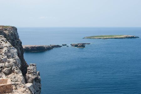 Small atoll and surfacing reef in the area of de Cavalleria lighthouse of the Spanish Balearic Islandsの写真素材