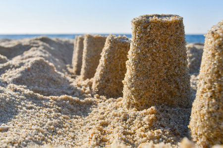 Castle built with sand with warm and light colors on the shoreline seen from below