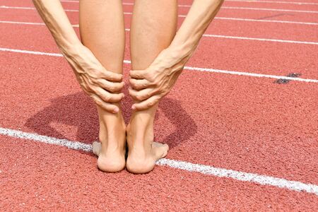 Woman without shoes during a moment of muscle stretchingの写真素材
