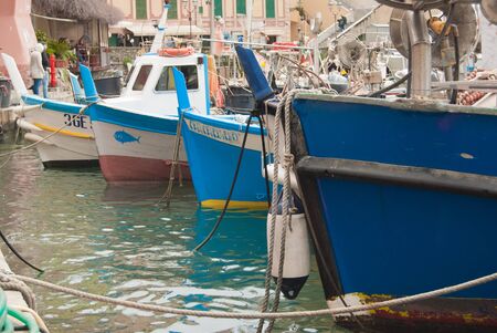 Ancient colorful boats and features of the small port of a small town near Genoa on the Mediterranean Sea in northern Italyの写真素材