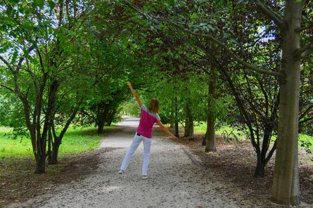 Woman happy and in harmony with nature with mobile phone in her pocket - Small break to enjoy nature without a devicesの写真素材