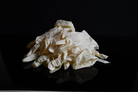 White latex gloves on a deep black backgroundの写真素材