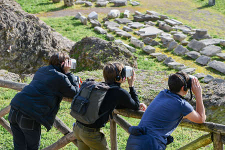 Three tourists with virtual reality mask while visiting the city of Rome in Italy - Circus Maximusの写真素材