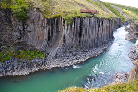 Very deep Canion with flowing river and with margins formed by natural vertical basalt columnsの写真素材