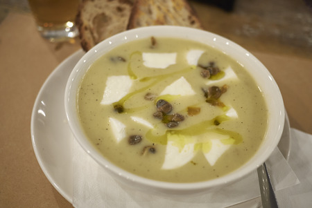 Potato soup with burrata cheese and capersの写真素材