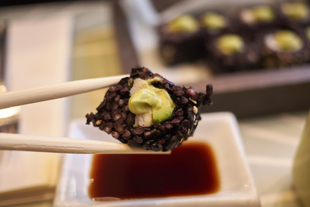 Black rice rolls with avocado and shrimpsの写真素材