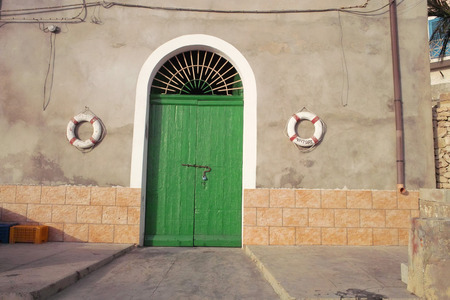 Lampedusa, Italy - July 30, 2008 : Green door entranceのeditorial素材