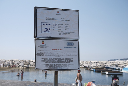 Naples, Italy - July 25, 2018 : Sign for unsafe bathing at Mergellina beachのeditorial素材