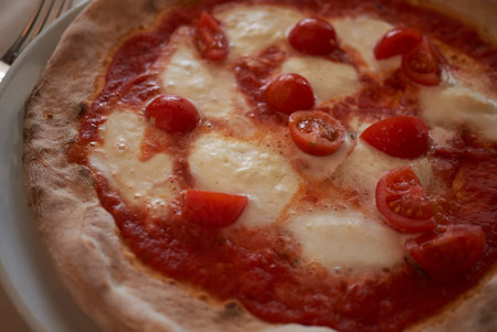 Pizza with buffalo mozzarella and cherry tomatoes