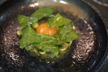 Egg yolk with asparagus and baby spinachの写真素材