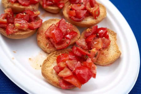 Dried bread, called friselle, with ripe tomatoes, oregano and olive oilの写真素材