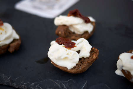 Whole grain frisella with burrata cheese and dried tomatoesの写真素材