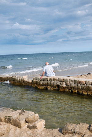 Lido Morelli, Italy - September 03, 2020: Man resting by the seaのeditorial素材