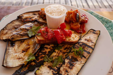 Vegetarian plate with grilled vegetables, bruschetta and ricotta cheeseの写真素材