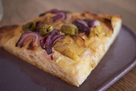Focaccia with olives, potatoes and red onionの写真素材