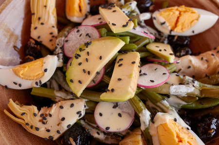 Salad with boiled eggs, avocado, green beans and black sesameの写真素材