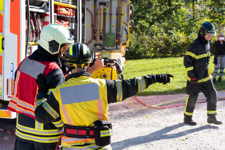 Firefighters consult at the scene of the accident as they will guide the rescue. In the background,...