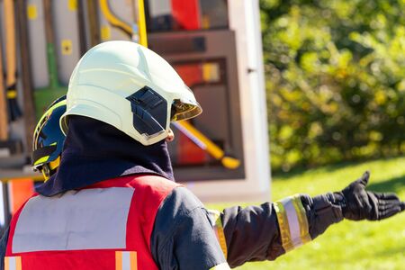 Firefighters consult at the scene of the accident as they will guide the rescue. Sunny day.のeditorial素材