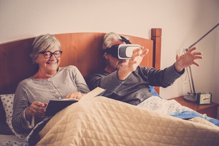 senior couple wake up with irony playing with virtual realityの写真素材