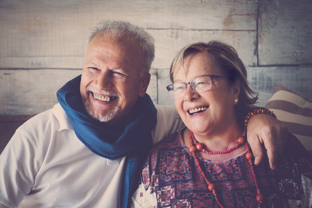 senior gentleman and lady smile and have fun at home with love. together forever concept lifestyle for beautiful elderly people.の写真素材