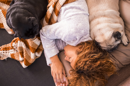 beautiul woman sleeping with her pug pug dog coupleの写真素材