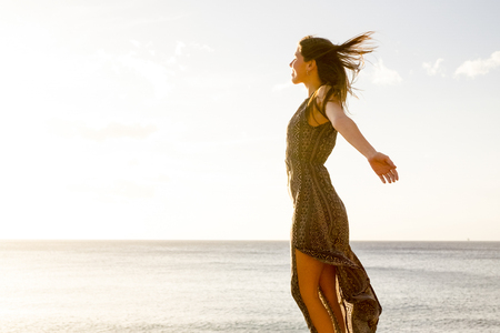 Young nice woman enjoy her freedom opening arms. Independent life and great feel with the world. Embrace all with satisfaction. Tenerife soul.の写真素材