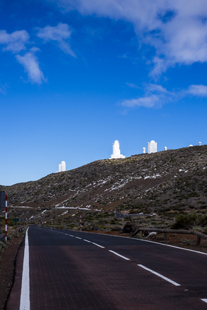 Colored season outdoor in mountain with curved road to travel and explore. asphalt and white lines to go to El Teide vulcan in Tenerife observatory parkの写真素材