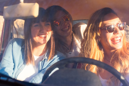 team of friends travel inside an old red car. Enjoy together the lifestyle and the vintage vehicle....