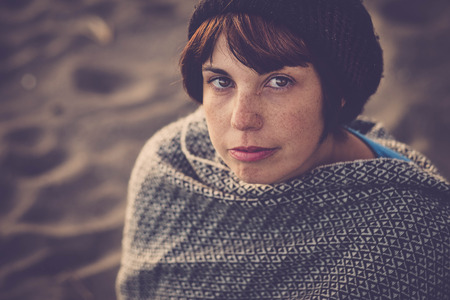 nice young lady portrait in vintage style filter. look at the camera with freckles on the faceの写真素材