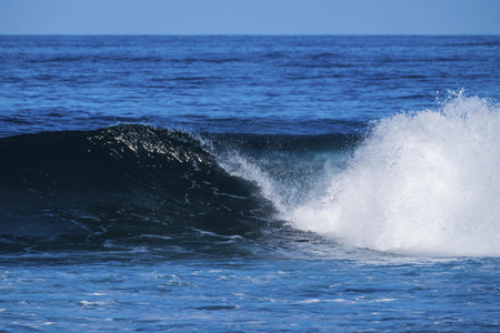 big beautiful blue wave for surfer. ocean of tenerife with power and wild waterの写真素材