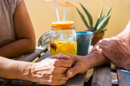 man and woman aged 60 years old woman drinking fruit from a glass vaseの写真素材