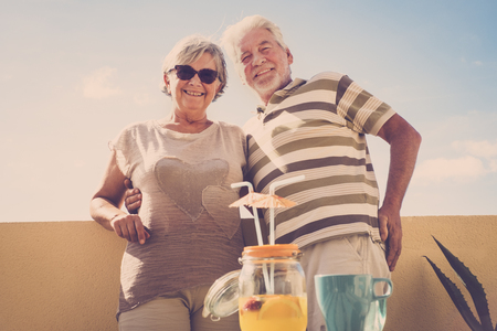 senior aged couple man and woman with white hair. hug nad life forever concept under a beautiful sunny dayの写真素材