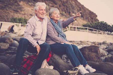 elderly couple and man at the beachの写真素材