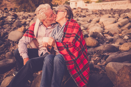 senior couple 70 years in love kissing on the beach in Tenerifeの写真素材