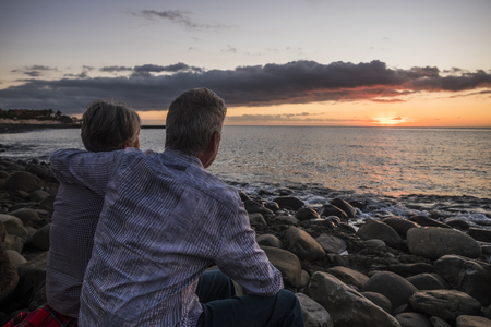 senior couple at sunset at the beach in Tenerifeの写真素材