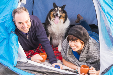 nice couple with a dog in a tentの写真素材