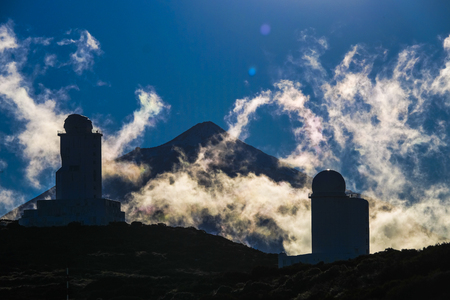 International observatory on El Teide mount vulcan in Tenerife. Windy day with clouds and amazinc colors. Technology science conceptの写真素材